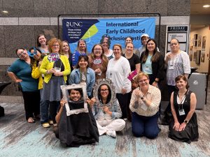 Participants pose in front the Inclusion Institute banner.
